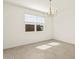 Sunlit dining room with a modern chandelier, windows, and tile floors at 37073 W La Paz St, Maricopa, AZ 85138