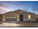 Charming single-story home featuring a two-car garage and low-maintenance desert landscaping at 37073 W La Paz St, Maricopa, AZ 85138