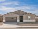 Charming single-story home featuring a two-car garage and low-maintenance desert landscaping at 37073 W La Paz St, Maricopa, AZ 85138