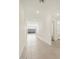 Bright hallway with tile flooring leads to a naturally lit living space and a bathroom at 37073 W La Paz St, Maricopa, AZ 85138