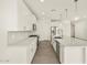 Bright kitchen with stainless steel appliances, pendant lighting, and gray backsplash at 37073 W La Paz St, Maricopa, AZ 85138