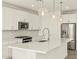 Modern kitchen features stainless steel appliances, a large island, and stylish pendant lighting at 37073 W La Paz St, Maricopa, AZ 85138