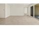 A well-lit living room with tile flooring and a sliding glass door leading to outdoor space at 37073 W La Paz St, Maricopa, AZ 85138