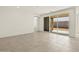 Spacious living area featuring tile floors and sliding glass doors opening to the backyard at 37073 W La Paz St, Maricopa, AZ 85138