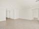 Bright living room featuring neutral tile flooring and recessed lighting, perfect for modern living at 37073 W La Paz St, Maricopa, AZ 85138