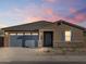 Charming single-story home showcasing a stylish blue garage door and complementary stone accents at 37358 W San Clemente St, Maricopa, AZ 85138