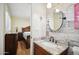 Updated bathroom with granite countertop and a round mirror at 4016 W Myrtle Ave, Phoenix, AZ 85051
