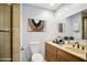 Well-maintained bathroom with a vanity, toilet, decorative mirror, and a tiled shower at 4016 W Myrtle Ave, Phoenix, AZ 85051