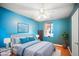 Tranquil bedroom with a bed, ceiling fan, natural light, and soothing blue walls at 4016 W Myrtle Ave, Phoenix, AZ 85051