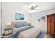 Inviting bedroom featuring a comfortable bed, natural light, and dark wood wardrobe at 4016 W Myrtle Ave, Phoenix, AZ 85051