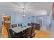 Dining area with a marble table and six chairs, kitchen view at 4016 W Myrtle Ave, Phoenix, AZ 85051