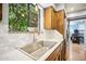 Kitchen boasts modern countertops, stainless steel sink and wood cabinets at 4016 W Myrtle Ave, Phoenix, AZ 85051