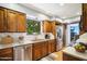 Updated kitchen featuring wood cabinets, stainless steel appliances, marble countertops, and a garden window at 4016 W Myrtle Ave, Phoenix, AZ 85051