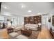 Spacious living room with hardwood floors, large built-in bookshelves, and views of the dining area at 4016 W Myrtle Ave, Phoenix, AZ 85051