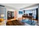 Bright home office with a dark wood desk, built-in bookshelves, and large windows overlooking the outside at 4016 W Myrtle Ave, Phoenix, AZ 85051