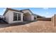 Newly constructed home with a spacious dirt backyard and a covered patio area at 42104 N Golden Trl, San Tan Valley, AZ 85140