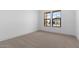 Neutral bedroom with plush carpet, natural light and views to the outdoors at 42104 N Golden Trl, San Tan Valley, AZ 85140