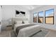 Staged bedroom boasts a tray ceiling, stylish wall art, and abundant natural light from multiple windows at 42104 N Golden Trl, San Tan Valley, AZ 85140