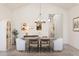 Bright dining room with an oval wooden table and six chairs at 42104 N Golden Trl, San Tan Valley, AZ 85140