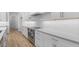 Modern kitchen featuring white cabinets, sleek countertops, stainless steel appliances, and stylish backsplash tiles at 42104 N Golden Trl, San Tan Valley, AZ 85140