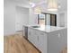 Bright kitchen with a large island, white cabinets, stainless steel appliances, and modern pendant lights at 42104 N Golden Trl, San Tan Valley, AZ 85140