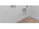 A view of the laundry room utility hookups and wood look tile flooring at 42104 N Golden Trl, San Tan Valley, AZ 85140