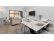 Open-concept living area with a modern dining table, comfortable seating, and a seamless flow at 42104 N Golden Trl, San Tan Valley, AZ 85140