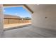 A covered patio space offers a great outdoor living area with a view to the backyard and surrounding houses at 42104 N Golden Trl, San Tan Valley, AZ 85140