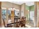 Dining room with wooden table, chairs, and large windows at 44710 N 18Th St, New River, AZ 85087