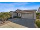 Single-story home with two-car garage and landscaping at 4523 E Rakestraw Ln, Gilbert, AZ 85298