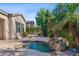 Private spa with waterfall feature nestled in a landscaped backyard at 4523 E Rakestraw Ln, Gilbert, AZ 85298