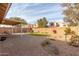 Landscaped backyard with patio and artificial grass at 4752 E Lavender Ln, Phoenix, AZ 85044