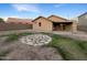 Landscaped backyard with a covered patio and stone pathway at 6038 S Connie Ln, Gilbert, AZ 85298
