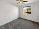 Spacious bedroom with ceiling fan and window at 6038 S Connie Ln, Gilbert, AZ 85298
