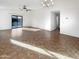 Sunlit living room with tile floors and sliding glass doors to backyard at 6038 S Connie Ln, Gilbert, AZ 85298