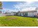 Spacious backyard with grassy area and home view at 6808 E Loma Land Dr, Scottsdale, AZ 85257