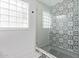 Modern bathroom with patterned tile and glass shower at 6808 E Loma Land Dr, Scottsdale, AZ 85257