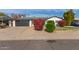 Charming single story home with landscaped front yard and modern garage door at 6808 E Loma Land Dr, Scottsdale, AZ 85257