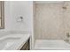 Updated bathroom with a bathtub, beige tile shower, and white countertop at 7648 E Holmes Ave, Mesa, AZ 85209
