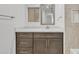 Modern bathroom with dark brown vanity, white countertop, and beige tile at 7648 E Holmes Ave, Mesa, AZ 85209