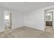 Spacious bedroom with plush carpeting and access to bathroom at 7648 E Holmes Ave, Mesa, AZ 85209