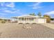 Ranch style home with carport and landscaped front yard at 7648 E Holmes Ave, Mesa, AZ 85209