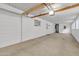 Attached garage with high ceiling and extra storage area at 7648 E Holmes Ave, Mesa, AZ 85209