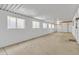 Spacious garage with concrete floor and ample storage space at 7648 E Holmes Ave, Mesa, AZ 85209