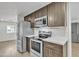 Modern kitchen with stainless steel appliances and quartz countertops at 7648 E Holmes Ave, Mesa, AZ 85209