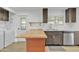 Updated kitchen with light wood island and stainless steel appliances at 7648 E Holmes Ave, Mesa, AZ 85209