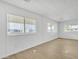 Bright and airy living room with new flooring and large windows at 7648 E Holmes Ave, Mesa, AZ 85209