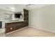 Open kitchen with breakfast bar and wood accent wall at 7905 W Thunderbird Rd # 309, Peoria, AZ 85381
