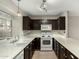 Modern kitchen with dark cabinets and white appliances at 7905 W Thunderbird Rd # 309, Peoria, AZ 85381