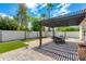 Outdoor patio features a pergola, dining table, and artificial turf at 8219 N 3Rd Ave, Phoenix, AZ 85021